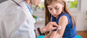A young girl gets a flu shot