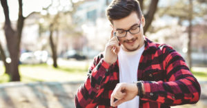 A man looks at his watch wondering when flu vaccines might be available