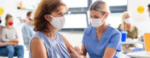 An elderly woman gets a flu shot