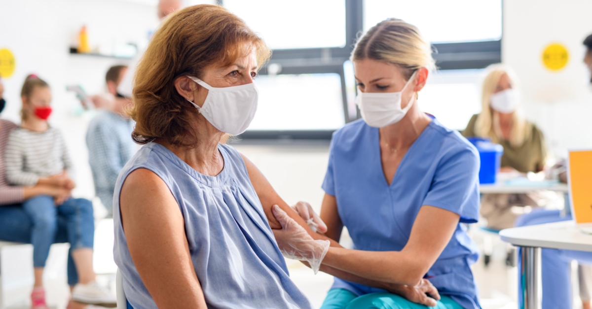 An elderly woman gets a flu shot